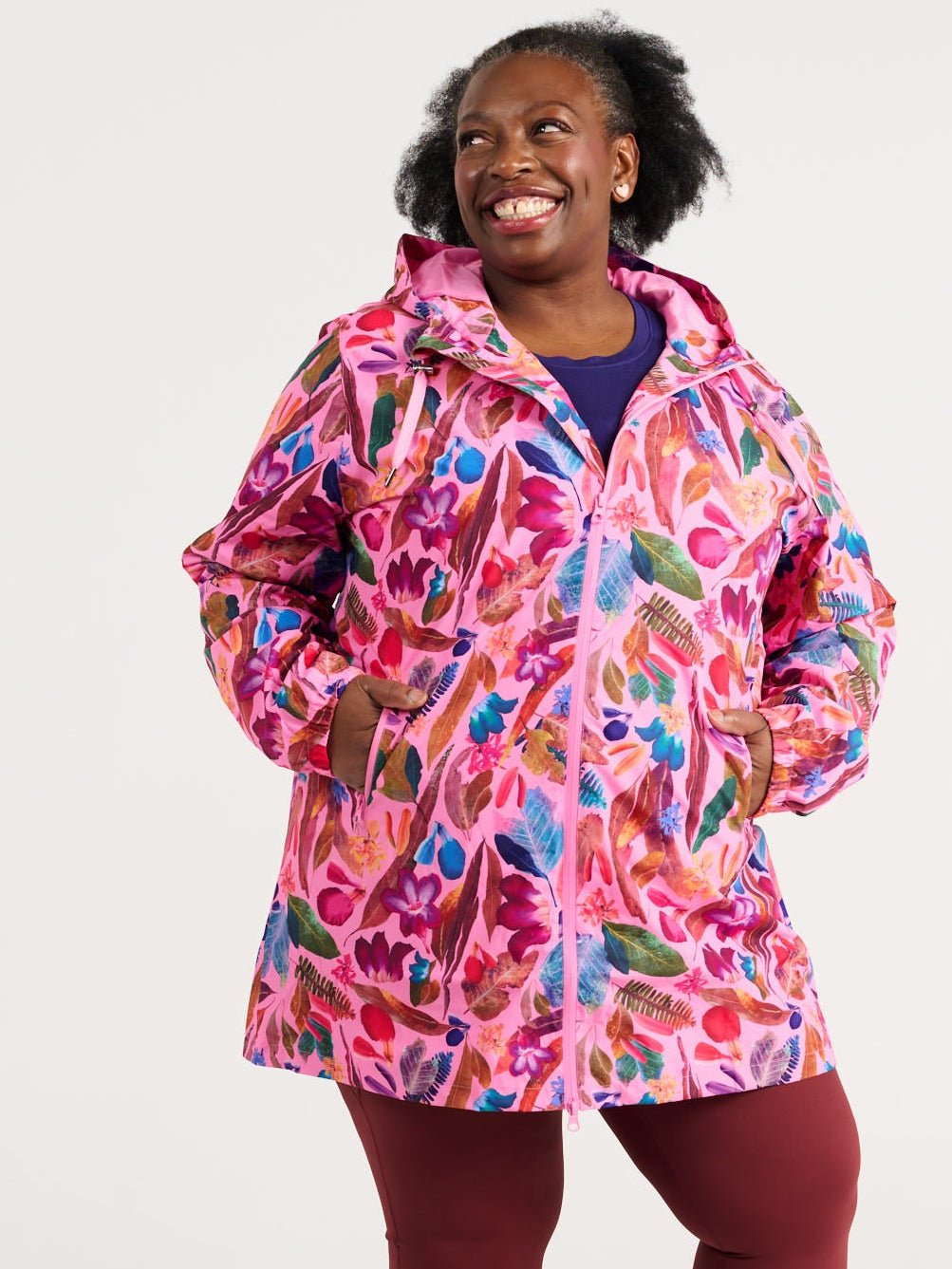 Zee wearing the Backyard Treasures Longline Raincoat in size 3XL, colourful printed waterproof raincoat
