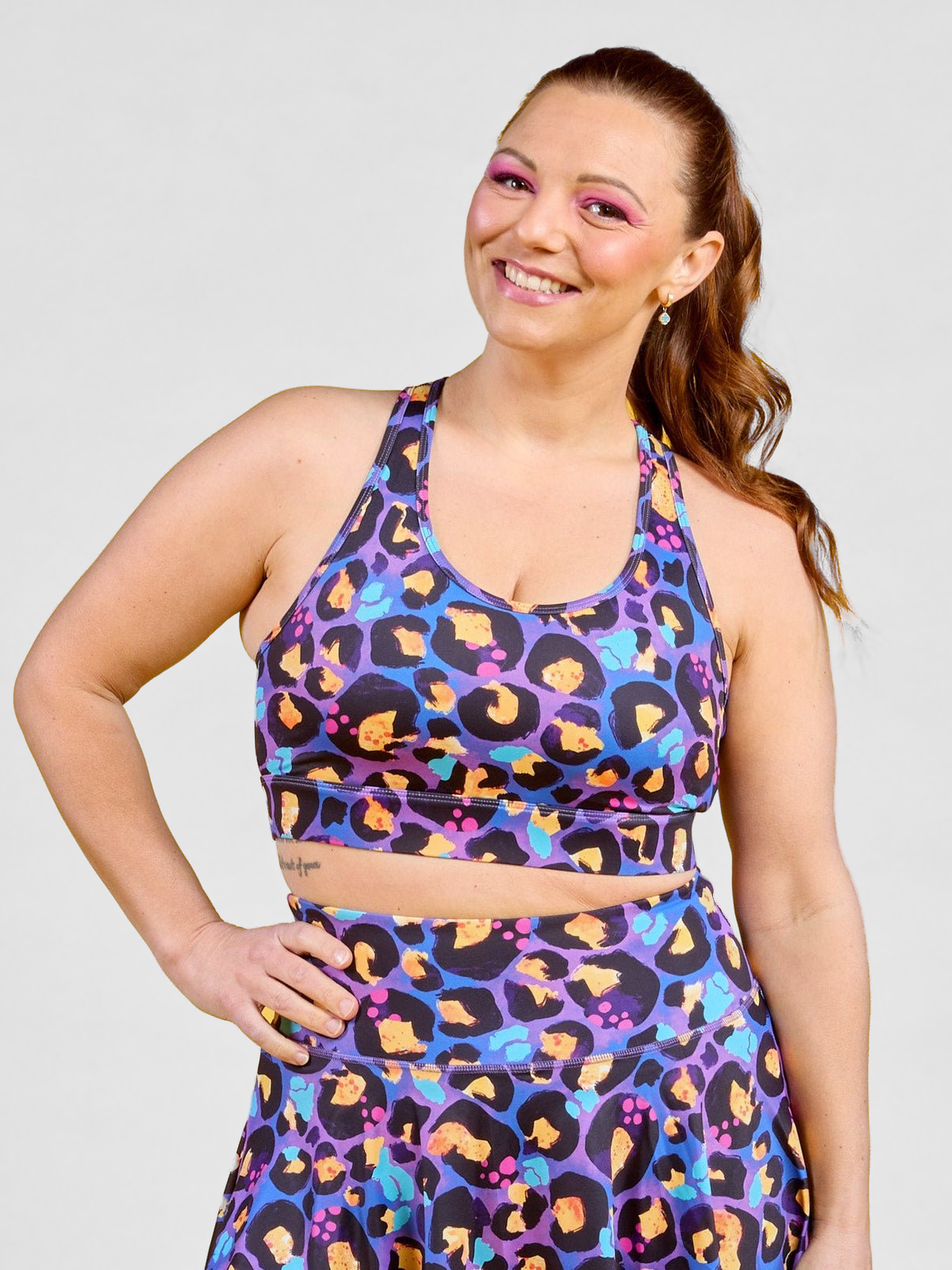 Berry Leopard Ultimate Racerback Crop - Racerback sports bra with sewn in padding medium support activewear, worn by Jaime