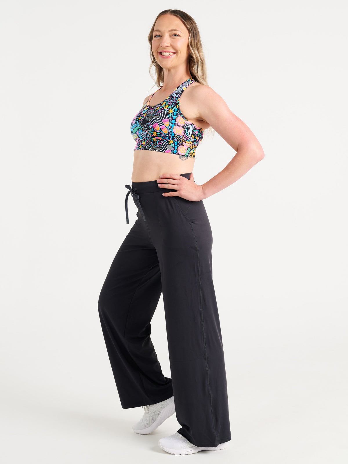 Jennifer wearing the Coastal Wildflowers Be Free Hookback Sports Bra, floral print sports bra with adjustable hookback