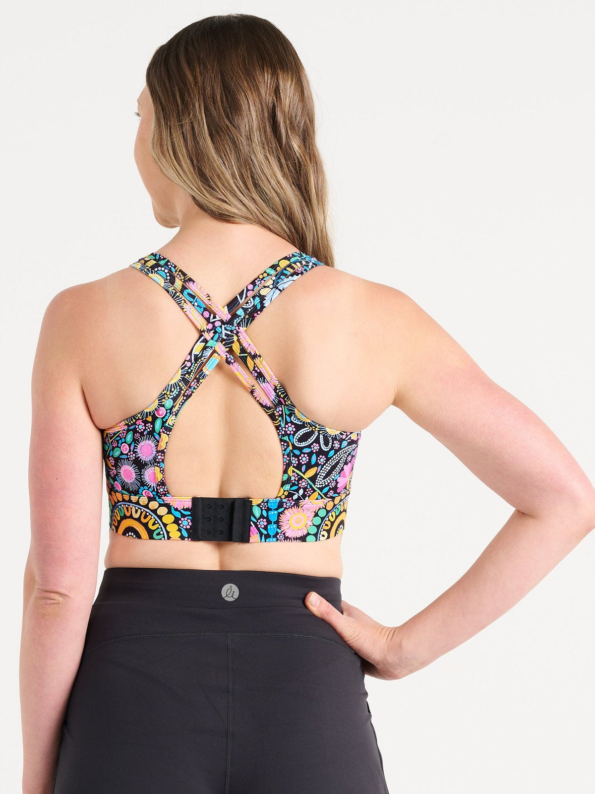 Jennifer wearing the Coastal Wildflowers Be Free Hookback Sports Bra, floral print sports bra with adjustable hookback
