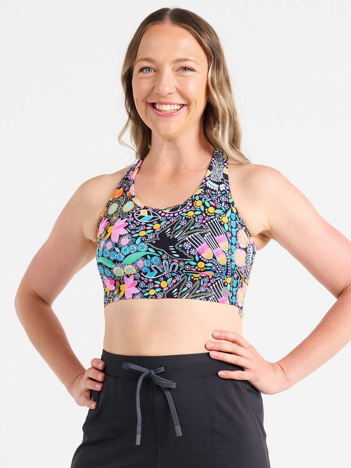 Jennifer wearing the Coastal Wildflowers Be Free Hookback Sports Bra, floral print sports bra with adjustable hookback