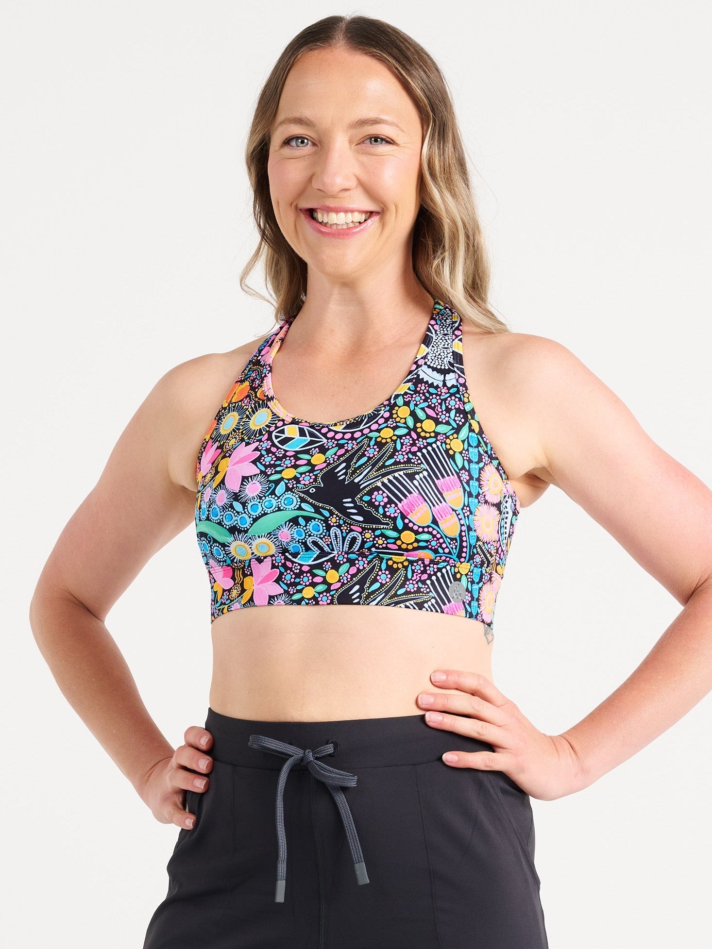Jennifer wearing the Coastal Wildflowers Be Free Hookback Sports Bra, floral print sports bra with adjustable hookback