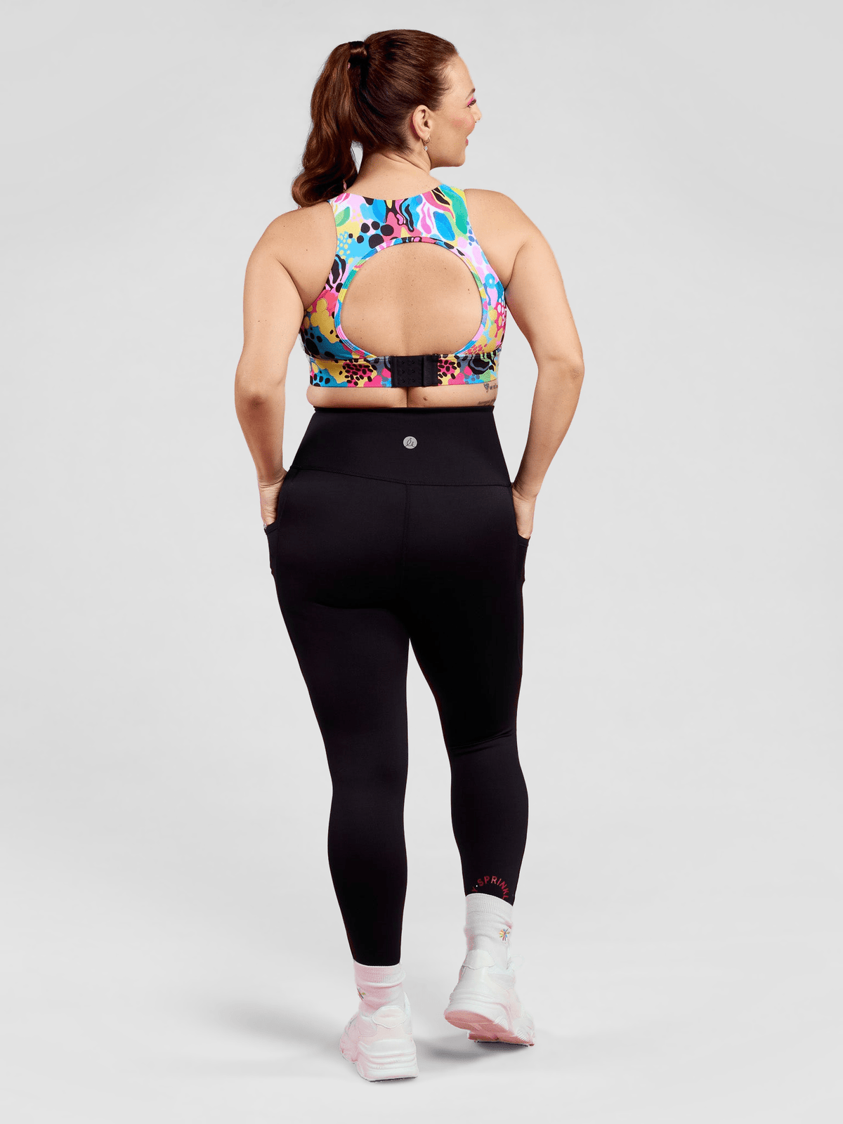 Rainbow at Heart Everyday Black Legging - 7/8 length - Back view black leggings with pockets sculpting fit, worn by Jaime