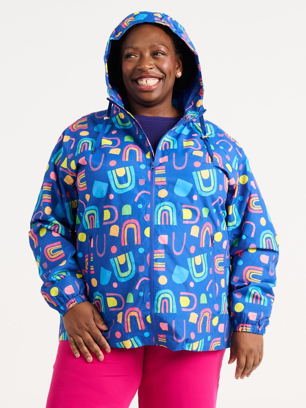 Zee wearing the Rainbow Warrior Raincoat in size 3XL, colourful rainbow printed waterproof raincoat