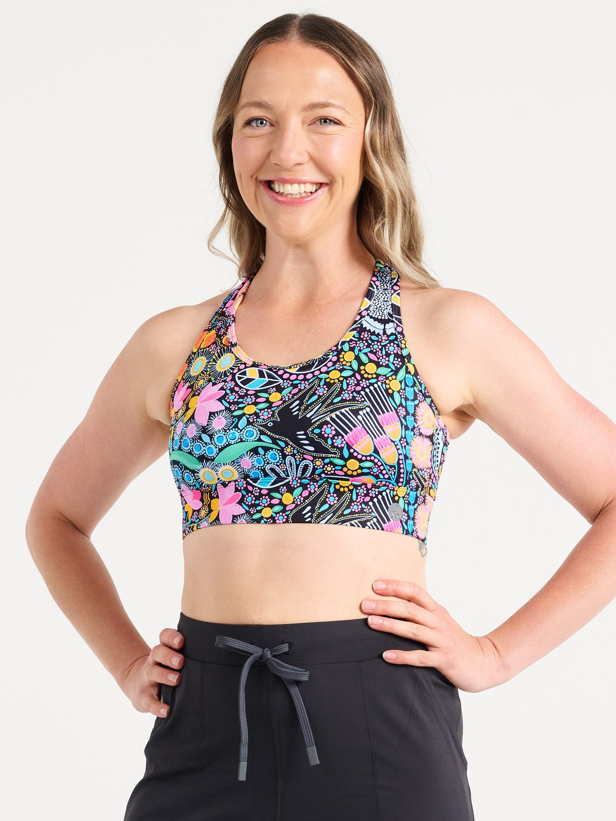 Jennifer wearing the Coastal Wildflowers Be Free Hookback Sports Bra, floral print sports bra with adjustable hookback