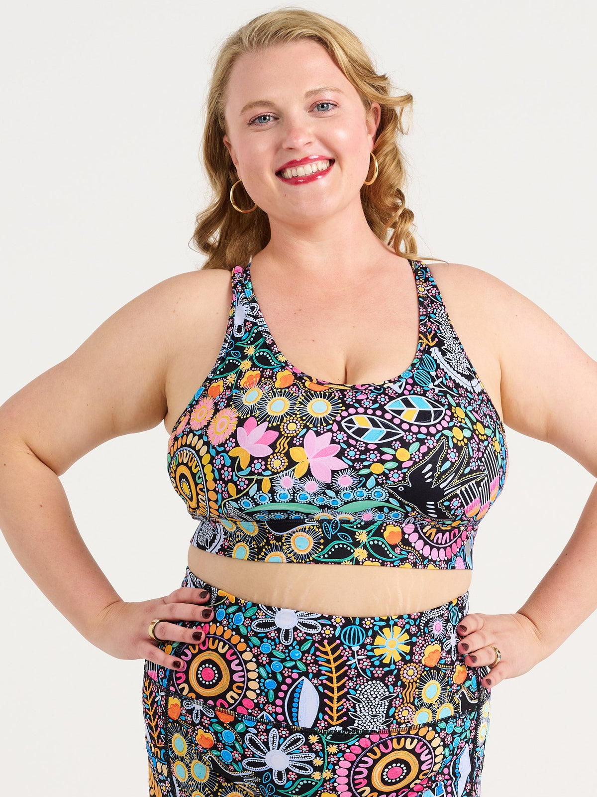 Ruby wearing the Coastal Wildflowers Be Free Hookback Sports Bra, floral print sports bra with adjustable hookback