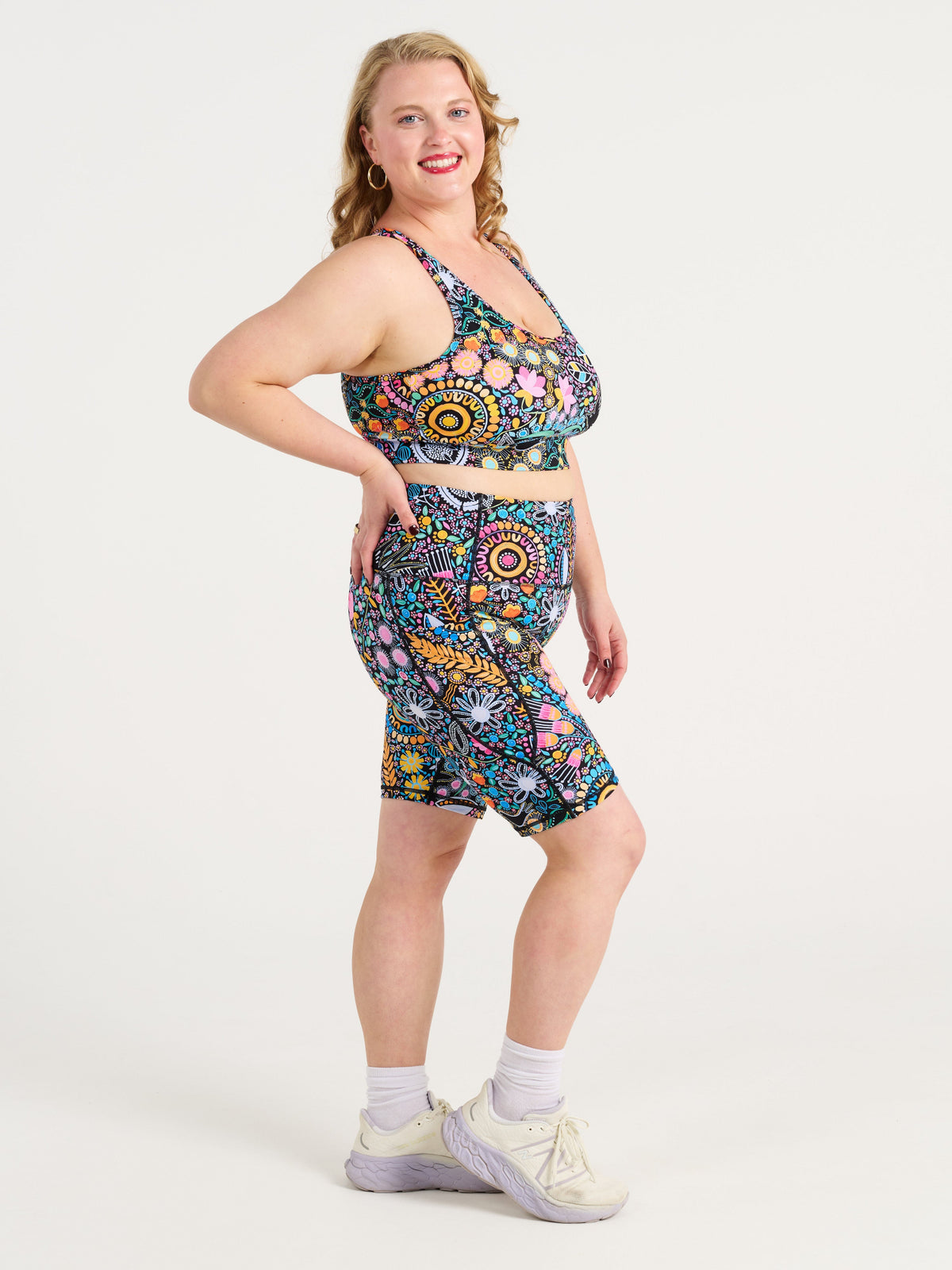 Ruby wearing the Coastal Wildflowers Be Free Hookback Sports Bra, floral print sports bra with adjustable hookback