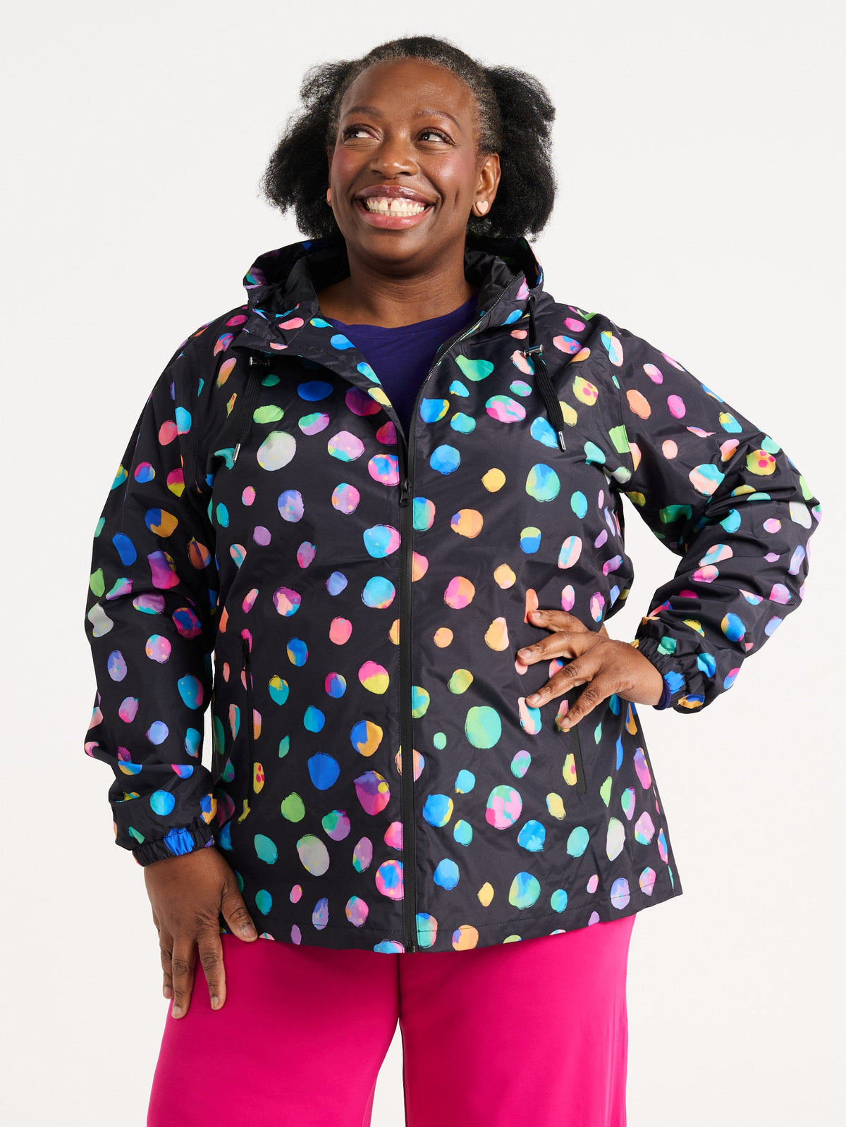 Zee wearing the Night Polka Raincoat in size 3XL, colourful rainbow spotted waterproof raincoat