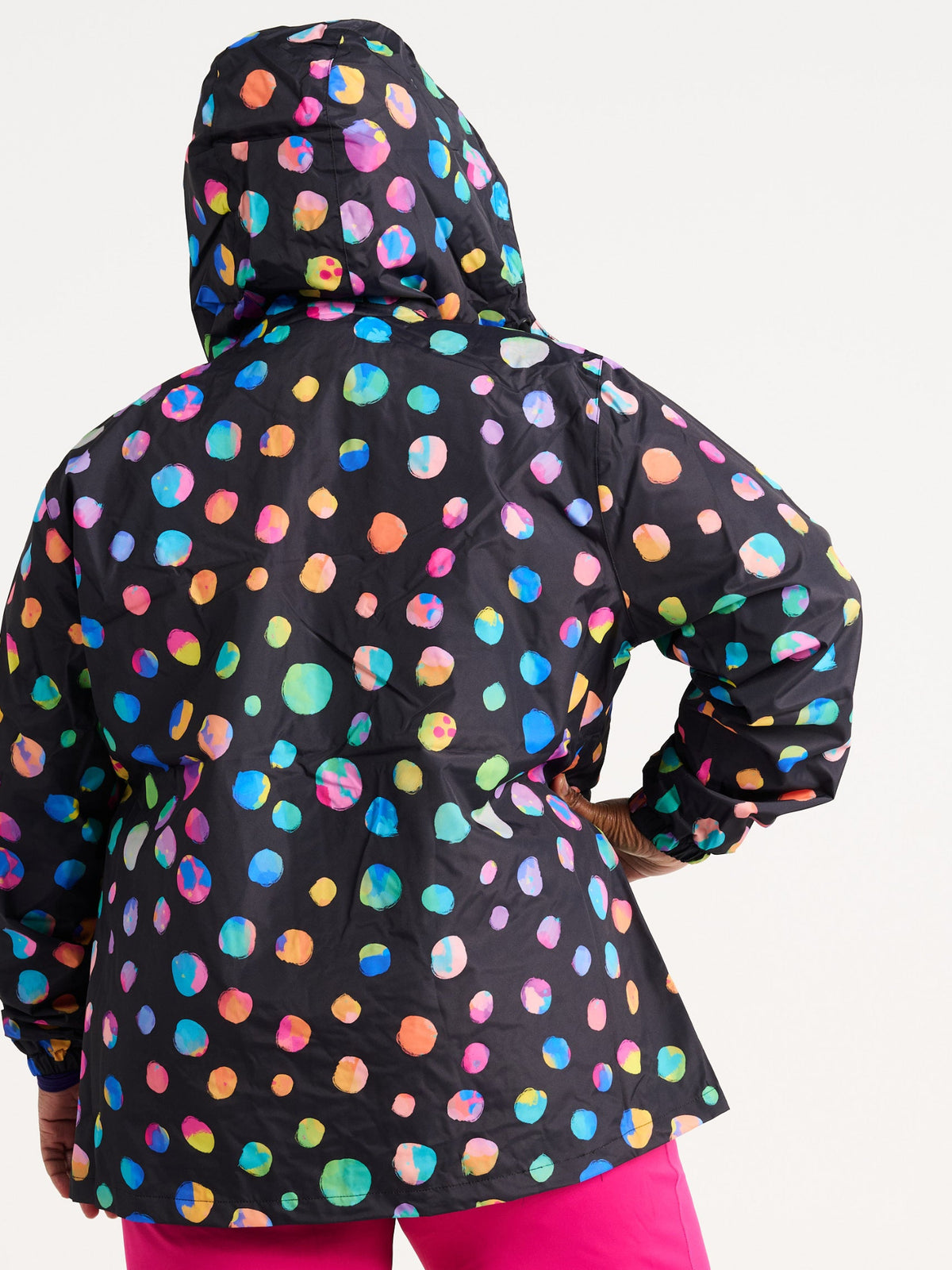 Zee wearing the Night Polka Raincoat in size 3XL, colourful rainbow spotted waterproof raincoat
