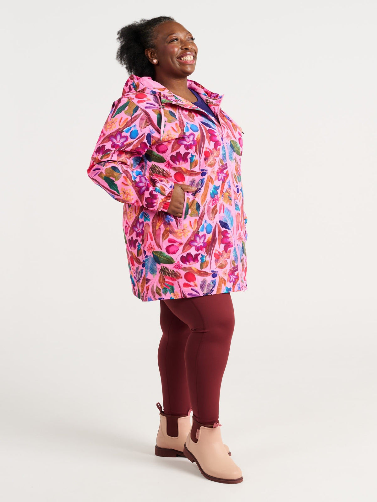 Zee wearing the Backyard Treasures Longline Raincoat in size 3XL, colourful printed waterproof raincoat