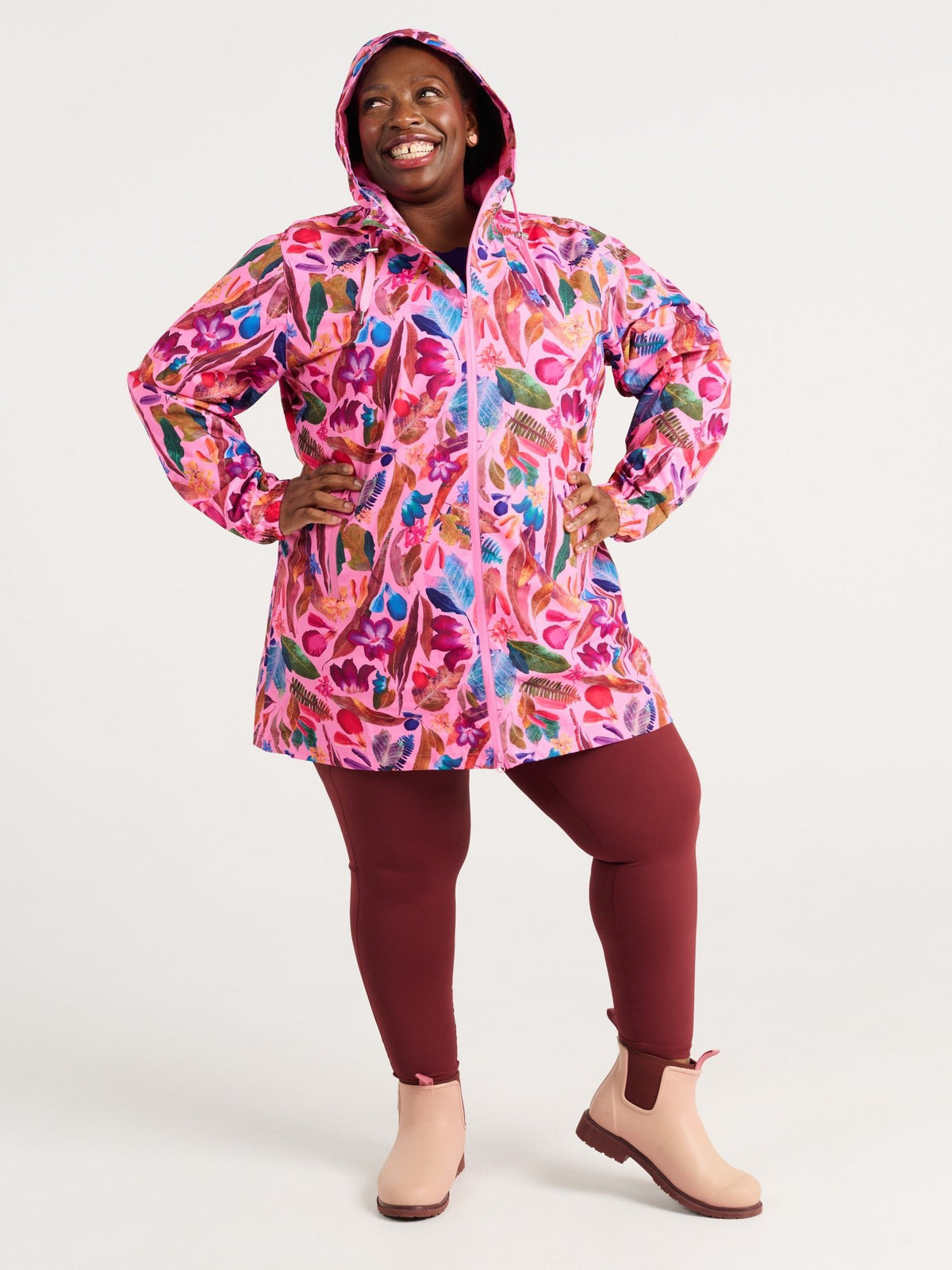 Zee wearing the Backyard Treasures Longline Raincoat in size 3XL, colourful printed waterproof raincoat