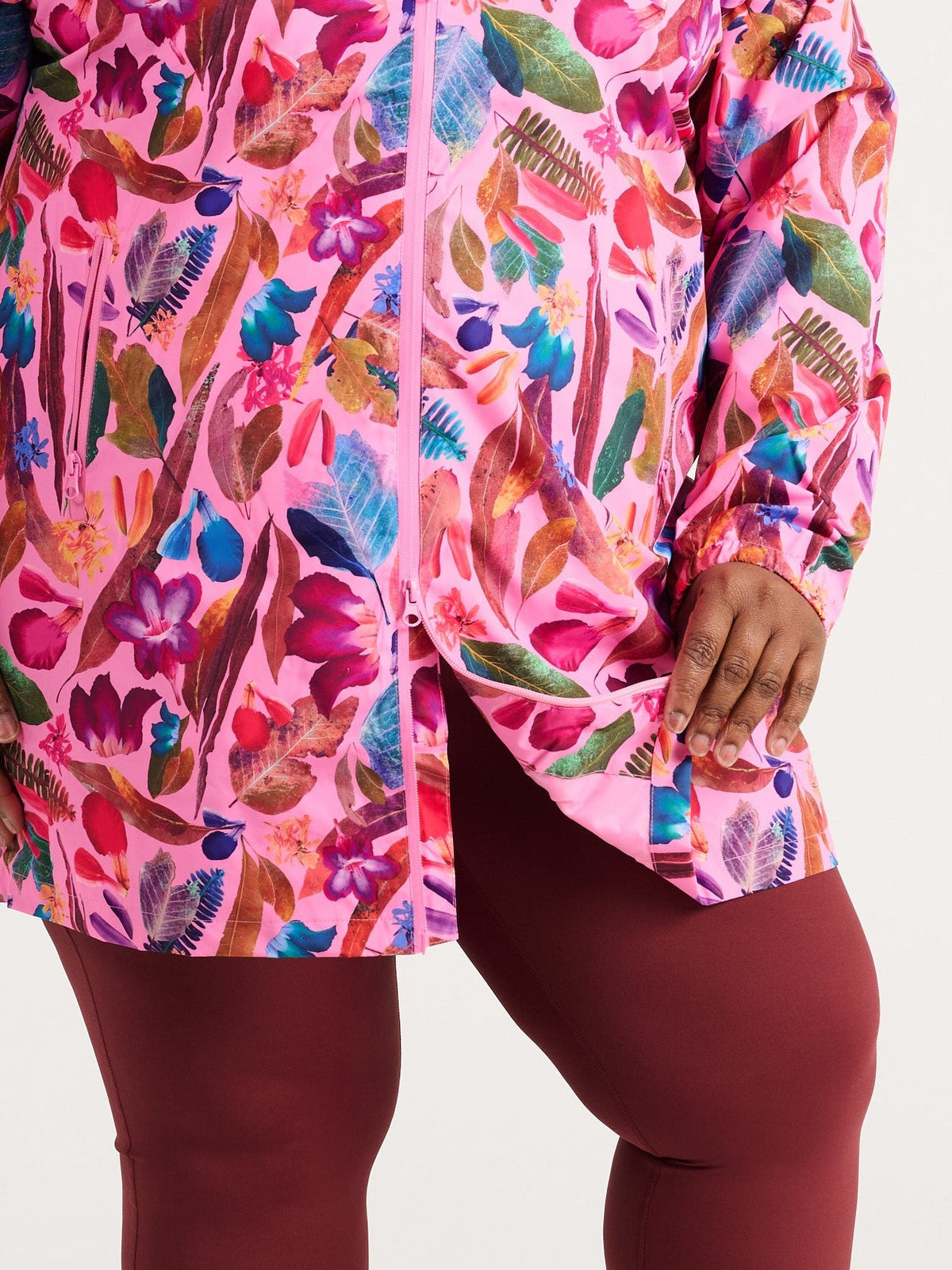 Zee wearing the Backyard Treasures Longline Raincoat in size 3XL, colourful printed waterproof raincoat