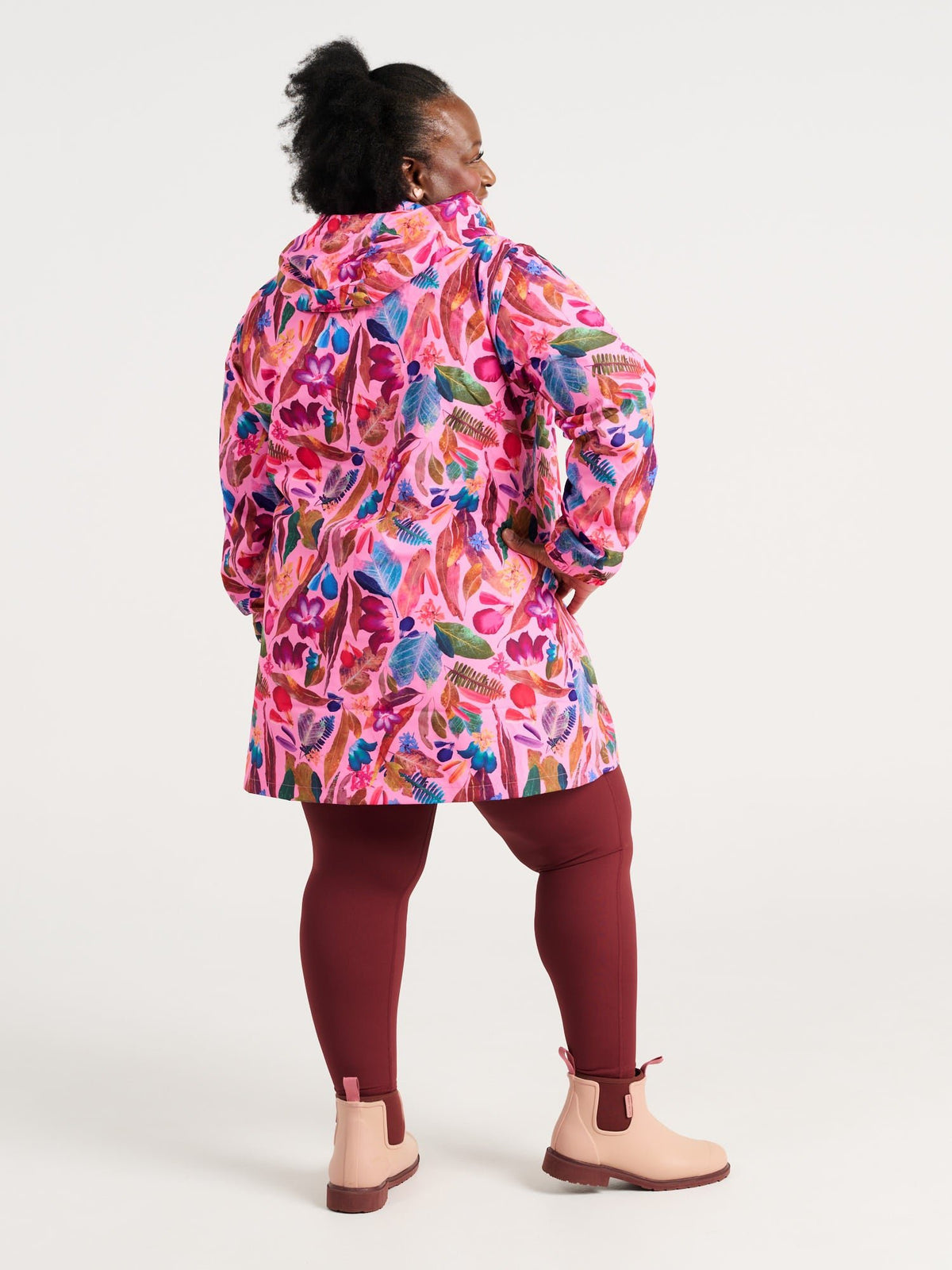 Zee wearing the Backyard Treasures Longline Raincoat in size 3XL, colourful printed waterproof raincoat