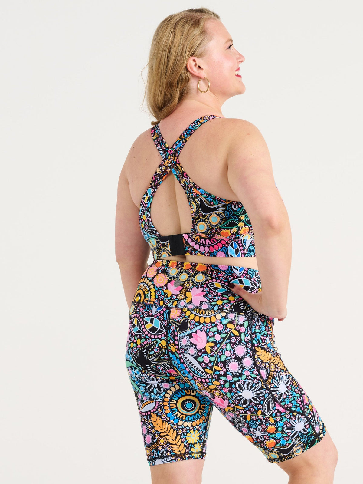 Ruby wearing the Coastal Wildflowers Be Free Hookback Sports Bra, floral print sports bra with adjustable hookback
