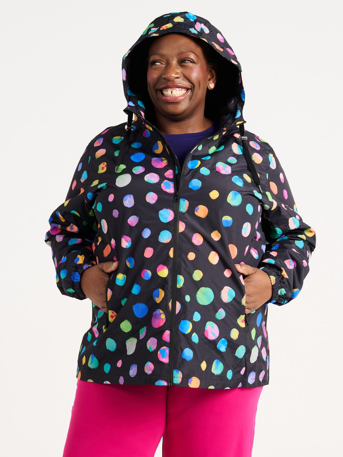 Zee wearing the Night Polka Raincoat in size 3XL, colourful rainbow spotted waterproof raincoat