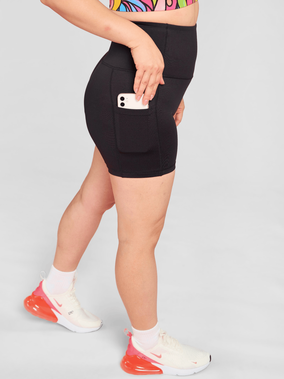 Everyday Black Shortie Shorts- mid tight black activewear shorts with pockets, worn by Faye