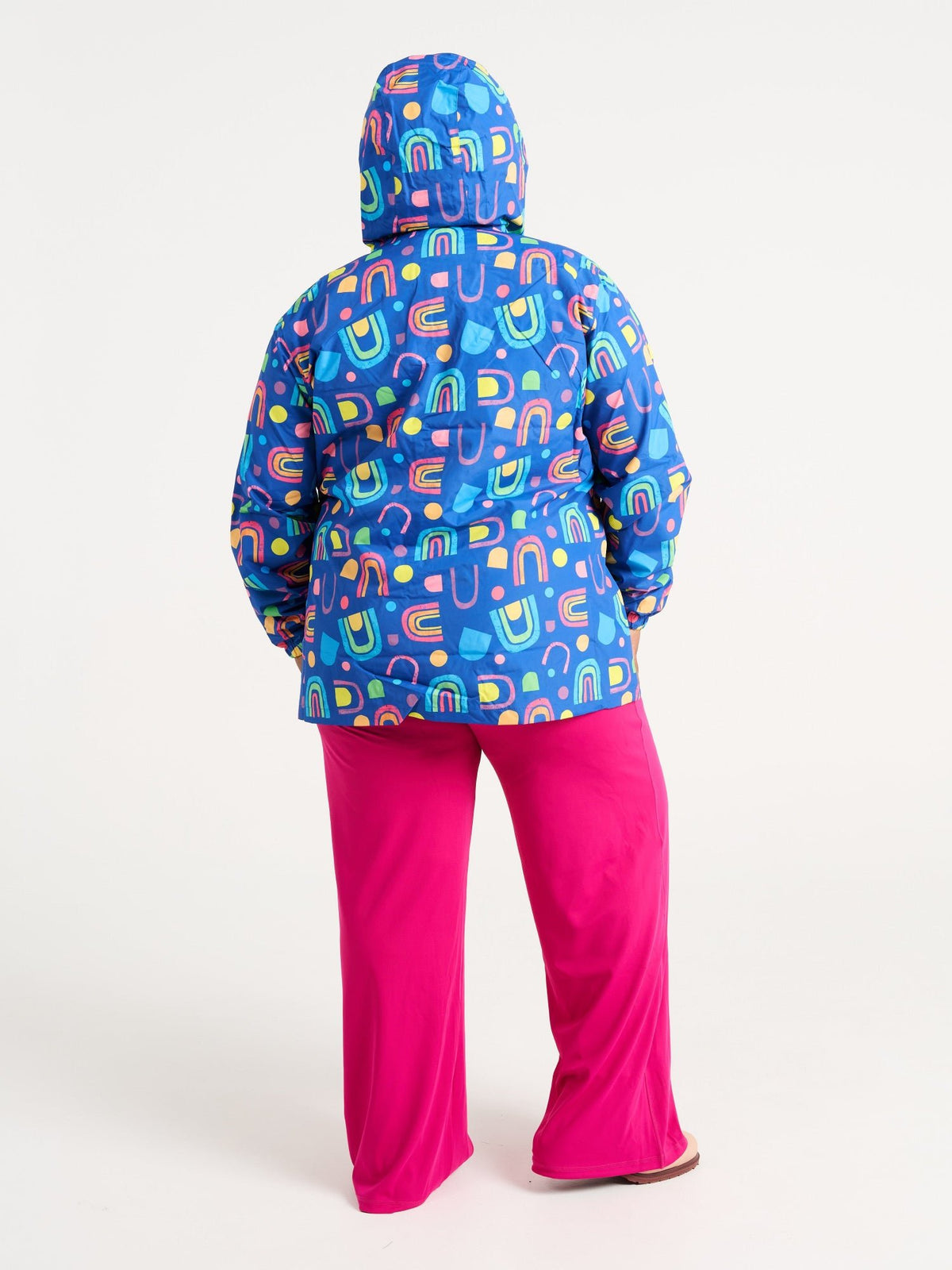 Zee wearing the Rainbow Warrior Raincoat in size 3XL, colourful rainbow printed waterproof raincoat