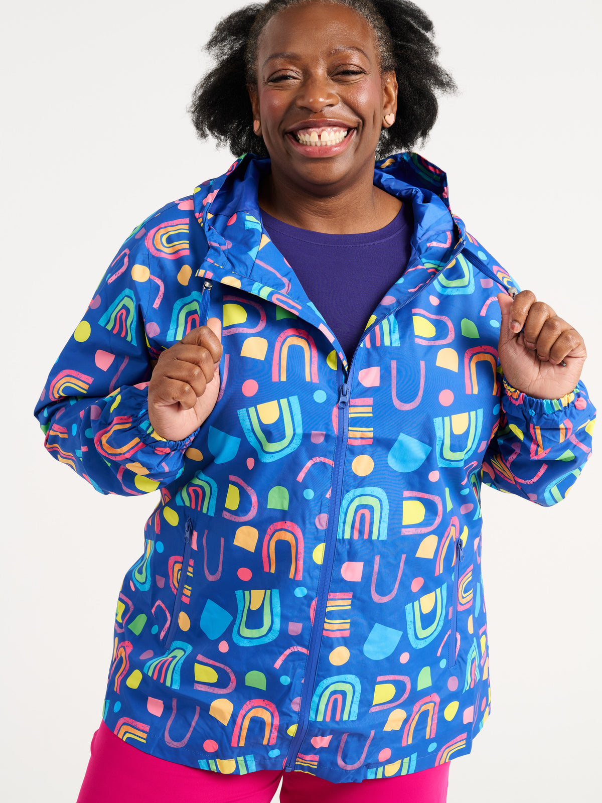 Zee wearing the Rainbow Warrior Raincoat in size 3XL, colourful rainbow printed waterproof raincoat