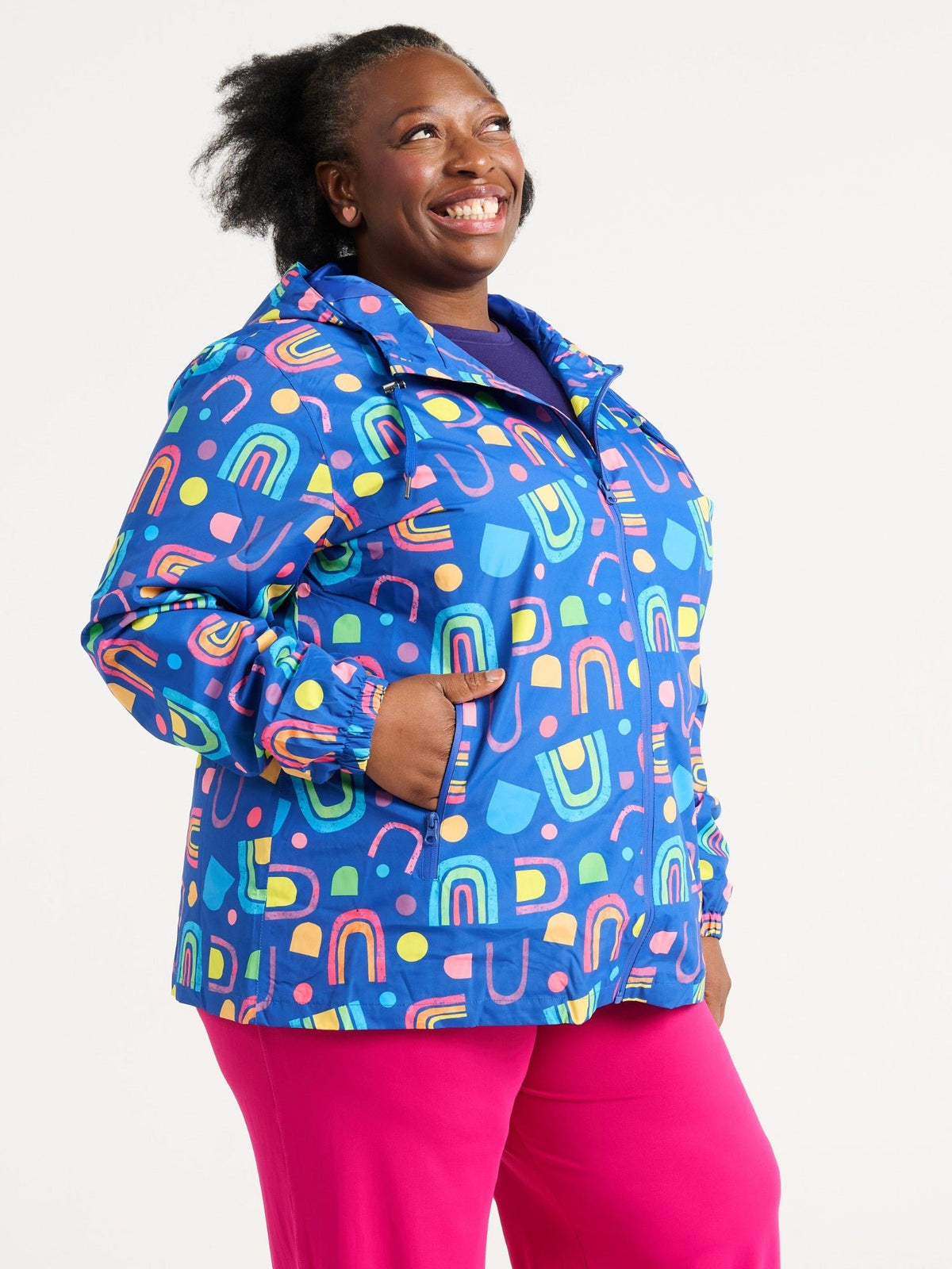 Zee wearing the Rainbow Warrior Raincoat in size 3XL, colourful rainbow printed waterproof raincoat